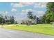 A picturesque single-story home with a lush lawn and a screened-in porch, perfect for outdoor enjoyment at 30413 Plymouth Creek Cir, Sorrento, FL 32776