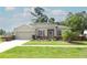 Charming single-story home features a well-manicured lawn, flower beds, and an attached two-car garage at 30413 Plymouth Creek Cir, Sorrento, FL 32776