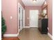 Hallway features tile floors, a decorative mirror, and tasteful decor, creating an inviting atmosphere at 30413 Plymouth Creek Cir, Sorrento, FL 32776