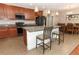 Well-equipped kitchen features a center island with seating, granite countertops, and modern appliances at 30413 Plymouth Creek Cir, Sorrento, FL 32776