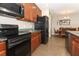 Well-equipped kitchen features dark cabinets, granite countertops, and modern appliances at 30413 Plymouth Creek Cir, Sorrento, FL 32776