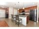 Modern kitchen features a granite island, stainless steel appliances, and stylish pendant lighting at 30413 Plymouth Creek Cir, Sorrento, FL 32776