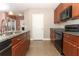 Open kitchen with black appliances, granite countertops, and ample cabinet space, perfect for cooking at 30413 Plymouth Creek Cir, Sorrento, FL 32776