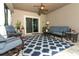 Lanai with ceiling fan, featuring patio furniture including rocking chairs, sofa, tables and outdoor rug at 30413 Plymouth Creek Cir, Sorrento, FL 32776