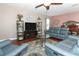 Comfortable living room with blue furniture, wood floors, and decorative accents at 30413 Plymouth Creek Cir, Sorrento, FL 32776