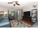 Cozy living room with a leather armchair and a view to the patio at 30413 Plymouth Creek Cir, Sorrento, FL 32776