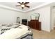 Spacious main bedroom with a decorative quilt, dresser, and natural light at 30413 Plymouth Creek Cir, Sorrento, FL 32776
