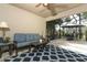 Relaxing covered patio with a ceiling fan, outdoor seating, and a view of the screened-in pool area at 30413 Plymouth Creek Cir, Sorrento, FL 32776