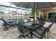 Spacious outdoor dining and lounging area beside a screened-in pool, perfect for entertaining guests at 30413 Plymouth Creek Cir, Sorrento, FL 32776