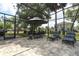 Outdoor patio with seating and dining space. Views of the pool and lawn create a relaxing oasis at 30413 Plymouth Creek Cir, Sorrento, FL 32776