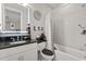 Modern bathroom features sleek fixtures, a shower-tub, and a stylish illuminated mirror at 3144 Players View Cir, Longwood, FL 32779