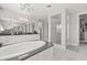 Bright bathroom featuring a glass-door shower, soaking tub, and double vanity with granite countertops at 3144 Players View Cir, Longwood, FL 32779