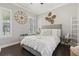 Comfortable bedroom with modern furniture, large windows, and stylish decorations creating a relaxing ambiance at 3144 Players View Cir, Longwood, FL 32779