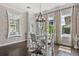 Stylish dining room with brick accent wall, modern light fixture and ample natural light at 3144 Players View Cir, Longwood, FL 32779