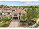 Stunning two-story home featuring a tile roof, paver driveway, manicured landscaping, and an attached two-car garage at 3144 Players View Cir, Longwood, FL 32779