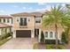 Stunning two-story home featuring a tile roof, balcony, arched windows, and a lush, landscaped yard with a palm tree at 3144 Players View Cir, Longwood, FL 32779