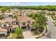 Aerial view of a two-story home with a tile roof, well-manicured lawn, and a paved driveway in a serene neighborhood at 3144 Players View Cir, Longwood, FL 32779