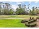 Picturesque golf course view with well-manicured greens, mature trees, and a cart path for easy access at 3144 Players View Cir, Longwood, FL 32779