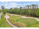 Scenic aerial view of the golf course with lush green fairways and mature trees creating a serene atmosphere at 3144 Players View Cir, Longwood, FL 32779