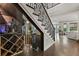 Elegant interior featuring a temperature controlled wine cellar, hardwood floors, and a decorative iron staircase at 3144 Players View Cir, Longwood, FL 32779