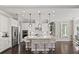 Modern kitchen with white cabinets, stainless steel appliances, a center island with seating, and hardwood floors at 3144 Players View Cir, Longwood, FL 32779