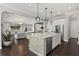 Beautiful open kitchen with white cabinetry, stone accent island and stainless steel appliances at 3144 Players View Cir, Longwood, FL 32779