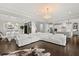 Bright, open-concept living area with hardwood floors, chandelier, and seamless flow to the dining and kitchen spaces at 3144 Players View Cir, Longwood, FL 32779