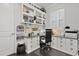 Home office with built-in shelving, custom cabinets, and lots of natural light at 3144 Players View Cir, Longwood, FL 32779