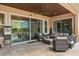 Covered patio featuring comfortable seating, ceiling fan, and sliding glass doors providing seamless indoor-outdoor living at 3144 Players View Cir, Longwood, FL 32779