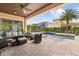 Inviting outdoor patio area with a pool, tropical landscaping, and comfortable seating at 3144 Players View Cir, Longwood, FL 32779