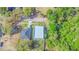 Aerial view of a contemporary gray home with flat roof, attached garage, and adjacent landscaped property at 315 E Magnolia St, Davenport, FL 33837