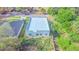 Aerial shot of a gray modern home with flat roof, integrated garage, and natural surroundings at 315 E Magnolia St, Davenport, FL 33837