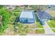 Aerial view of modern gray home with flat roof, attached garage, and ample space for landscaping at 315 E Magnolia St, Davenport, FL 33837