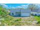Contemporary gray home with an attached garage and a yard ready for landscaping at 315 E Magnolia St, Davenport, FL 33837