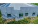 A modern home with a sliding glass door and windows on the unfinished lawn at 315 E Magnolia St, Davenport, FL 33837