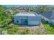 Modern gray home features a flat roof, integral garage, and a raw outdoor space at 315 E Magnolia St, Davenport, FL 33837