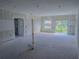Bright and spacious unfinished living room showcasing sliding glass doors and a neutral color scheme at 315 E Magnolia St, Davenport, FL 33837