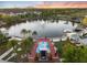 Beautiful aerial view of a serene lake with fountain, park, surrounding lush greenery, and nearby residences at 336 Center Lake Ln # A-2, Oviedo, FL 32765
