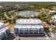 Gorgeous aerial view shows the townhome community and its proximity to a scenic pond and surrounding lush green landscape at 336 Center Lake Ln # A-2, Oviedo, FL 32765