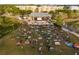 Expansive aerial view of community gathering in park setting for an outdoor movie night at 336 Center Lake Ln # A-2, Oviedo, FL 32765