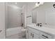 A modern bathroom featuring a tiled shower-tub, white vanity, and black fixtures at 336 Center Lake Ln # A-2, Oviedo, FL 32765