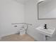Neutral powder room with beige tile, handrails, white fixtures, and sink with dark faucet at 336 Center Lake Ln # A-2, Oviedo, FL 32765