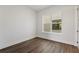 Bright bedroom with a large window and modern dark wood-look flooring at 336 Center Lake Ln # A-2, Oviedo, FL 32765