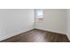 Cozy bedroom featuring wood floors, a window, and neutral paint throughout at 336 Center Lake Ln # A-2, Oviedo, FL 32765