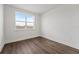 Bedroom featuring wood floors, a large window, and neutral paint throughout at 336 Center Lake Ln # A-2, Oviedo, FL 32765