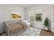 A cozy bedroom featuring a daybed, large window, modern rug and wood-look floor at 336 Center Lake Ln # A-2, Oviedo, FL 32765