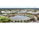 Aerial view featuring a pond, lush landscaping, and colorful townhomes highlights the desirable community at 336 Center Lake Ln # A-2, Oviedo, FL 32765