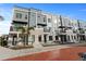Exterior of modern townhomes with gray siding, stone accents, and black balconies at 336 Center Lake Ln # A-2, Oviedo, FL 32765