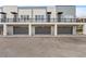 Modern townhome exterior featuring a gray garage door, a porch, and dark railings at 336 Center Lake Ln # A-2, Oviedo, FL 32765