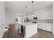Modern kitchen with white cabinets, quartz countertops, stainless steel appliances, and a large island at 336 Center Lake Ln # A-2, Oviedo, FL 32765